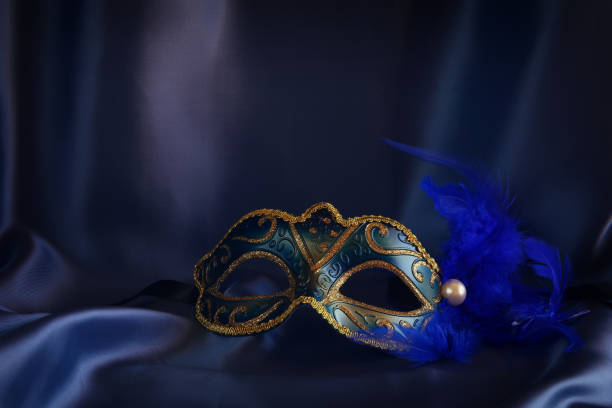 Image of elegant venetian mask on blue silk background