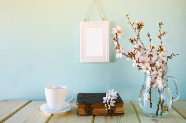 istock old book, cup of coffee next to spring white flowers 645107378