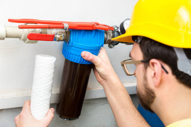 istock water filtration - plumber changing dirty water filter 645107512