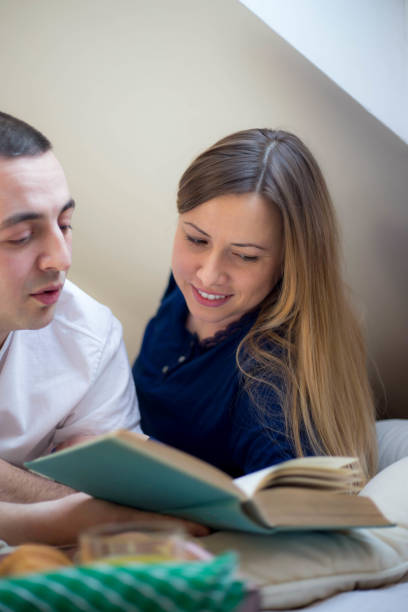 istock Happy couple relaxing together on their bed 645108166
