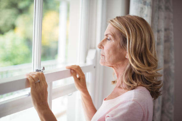 istock Thoughtful senior woman looking out from the window 645117014