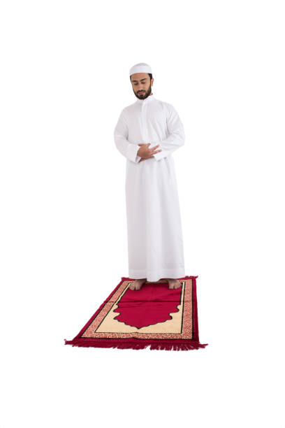 istock Arab muslim man praying on a red carpet 645124068