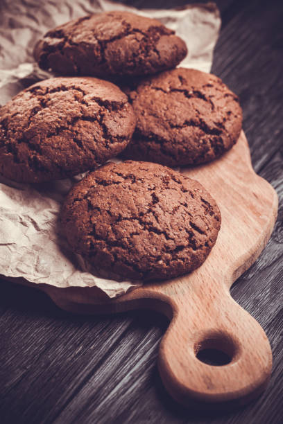 istock chocolate cookies with chocolate on wooden background 645128962