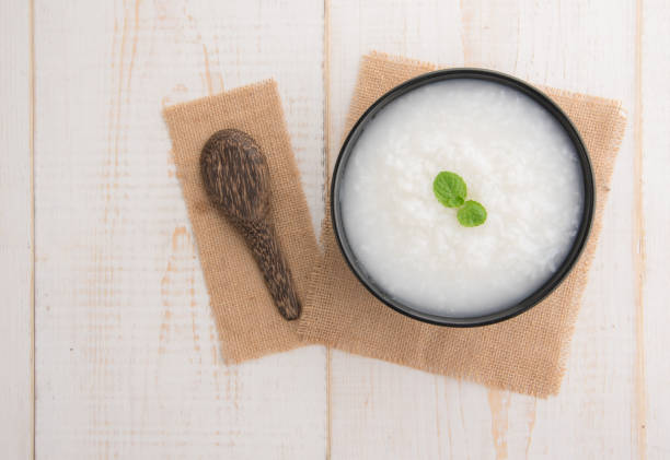 istock Mush or boiled rice in bowl on wooden table 645129060