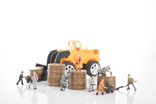 miniature people workers on money coin piles. business invesment and finance concept.