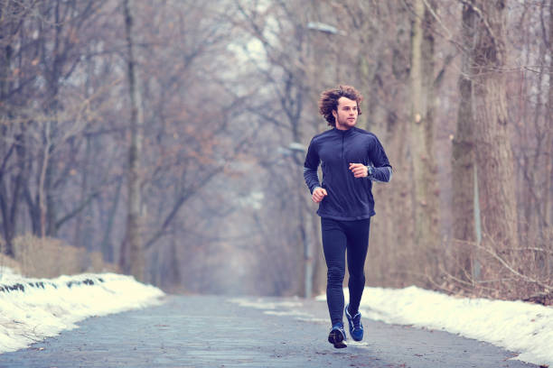 istock Young runner running in the park in spring, autumn on nature 645133900