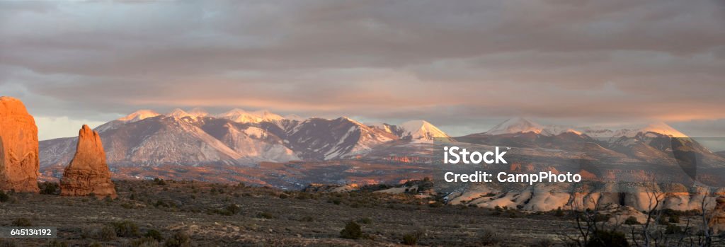 The Salt Panorama Composite image of the La Sal Mountains from Arches National Park, Utah. American Southwest. Cloud - Sky Stock Photo