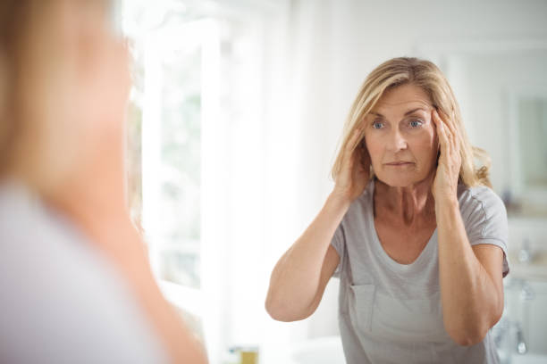 istock Frustrated senior woman looking at mirror 645134274