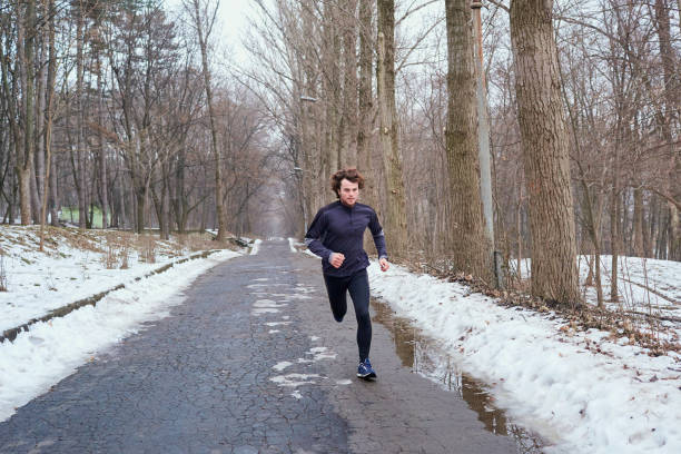 istock Young runner running in the park in spring, autumn on nature 645134724