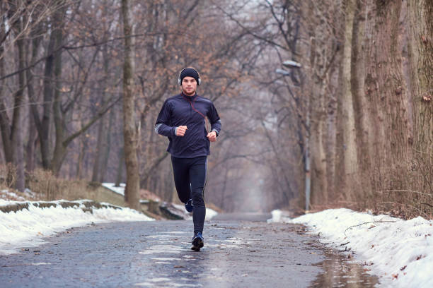 istock Young runner running in the park in spring, autumn on nature 645135554