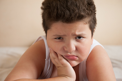 Painful Fat Boy Holding His Face With His Hand Lying Stock Photo - Download Image Now - iStock Painful Fat Boy Holding His Face With His Hand Lying Stock Photo - Download Image Now - iStock