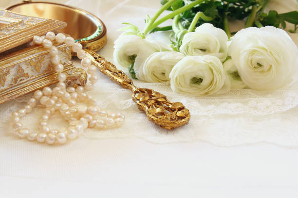 istock delicate lace fabric, hand mirror and white flowers 645137944