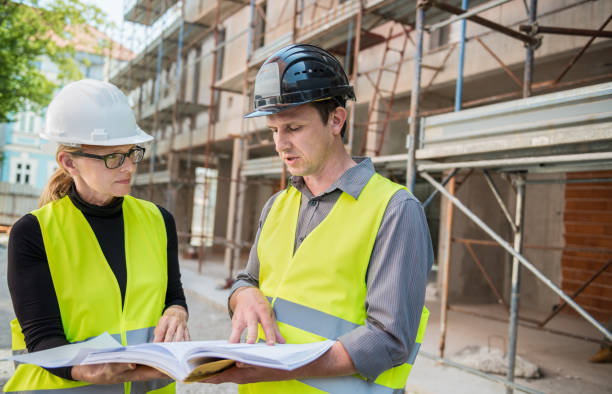 istock Architects Reviewing Blueprints Together 645138398