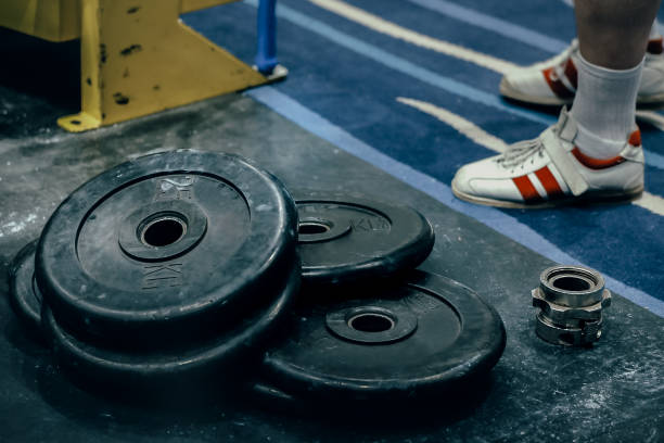 bumper plates are on floor in sport gym