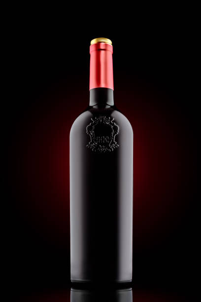 istock Red wine bottle with emboss at the black background 645165162
