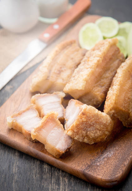 istock Fried pork belly with knife on wood background 645169520