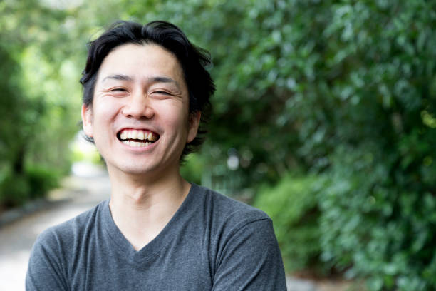 I am always happy! Portrait of a young and cheerful japanese man. japanese ethnicity stock pictures, royalty-free photos & images