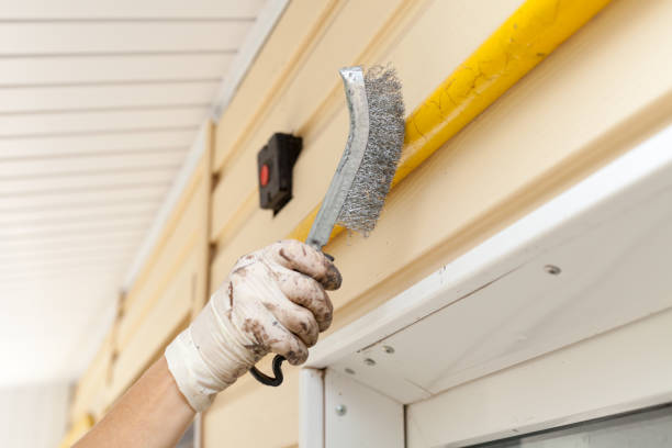 istock Removal coats of paint from gas pipe using metal brush. 645175980
