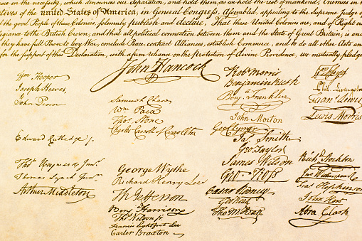 Copy of the USA Declaration of Independence written in antique script. Close up view of portion of the signature page.  Great background for patriotic themes.