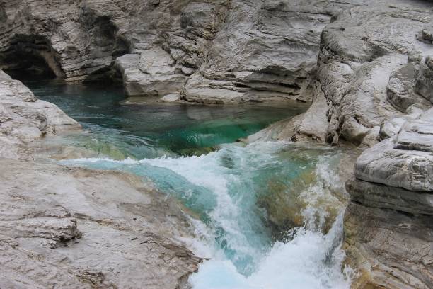 Very particular white river rocks carved by decades of  turques water Very particular white river rocks carved by decades of  turques water albania photos stock pictures, royalty-free photos & images