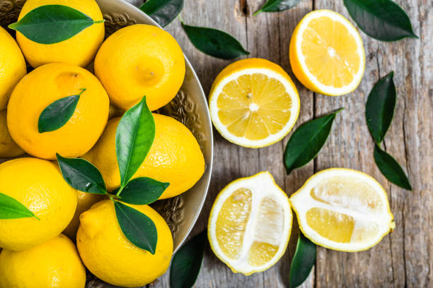 istock Fresh lemons on market table, top view 645183506