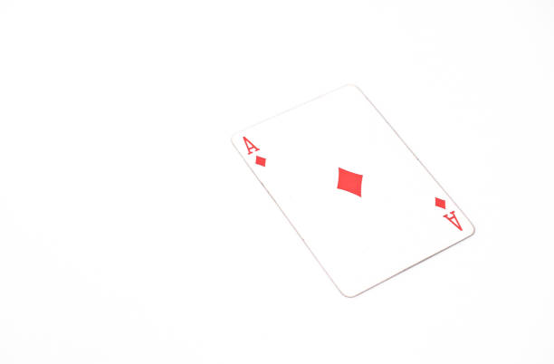 Close up shot of a playing card on a green surface, ace of diamonds