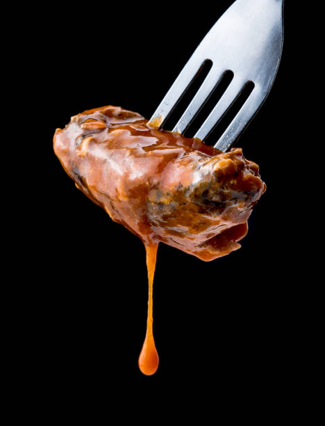 istock Sardines fish in tomato sauce with fork on black background 645188158