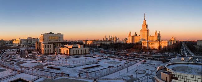 A wide angle spring sunset picture of the campus of Lomonosov Moscow State University under bright sunny sky.