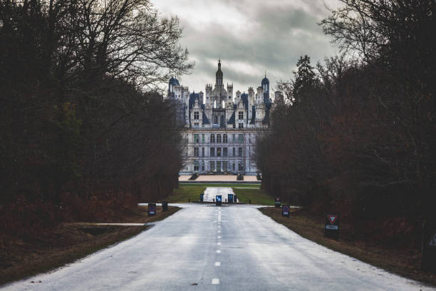 Chambord castle entrance road. Located in the Loire valley the royal Château de Chambord blends traditional French medieval forms with classical Renaissance structures. The building, which was never completed, was constructed by King Francis I of France.