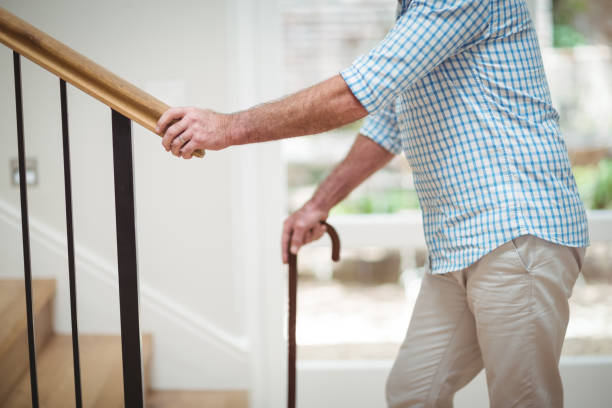 istock Senior man climbing upstairs with walking stick 645204620