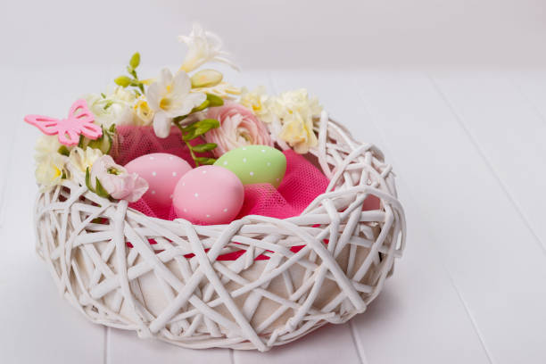 istock Basket of easter eggs with flowers 645211356