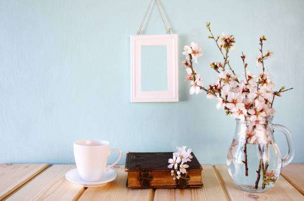 istock old book, cup of coffee next to spring white flowers 645214936
