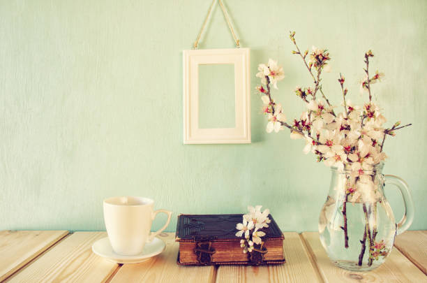 istock old book, cup of coffee next to spring white flowers 645214952