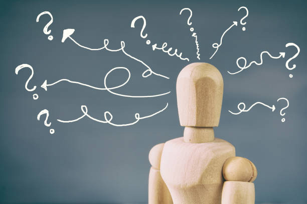 istock image of wooden dummy with may question marks 645215030