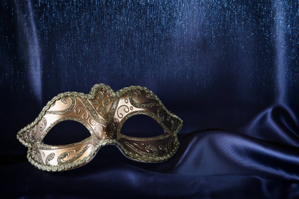 istock gold venetian mask on blue silk background 645215362