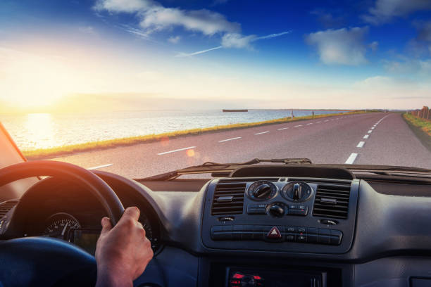 istock Asphalt road along the sea at sunset 645215498