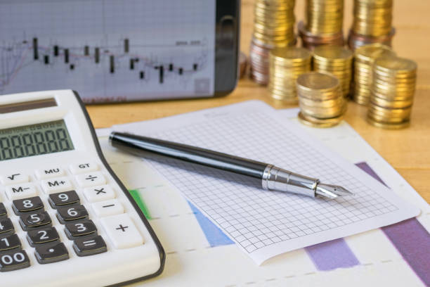 istock Metal coins and calculator on a rustic table. 645215772