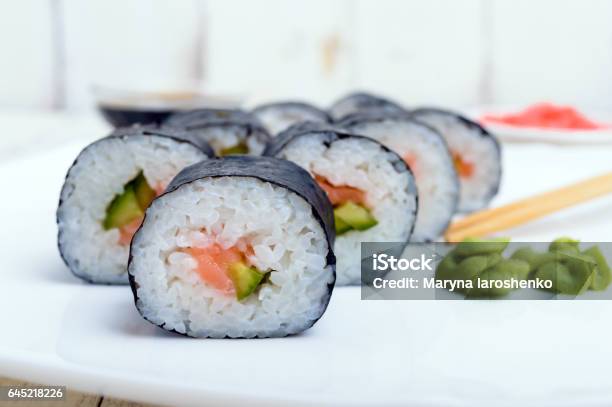 Traditional Eastern Dish With Salmon Sushi Rolls On A White Plate Stock Photo - Download Image Now