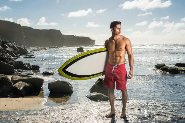 Photo of Hispanic Man With His Surboard