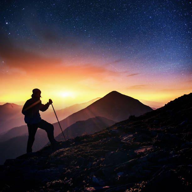 istock Happy man standing on a cliff. Fantastic starry sky 645221172