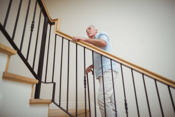 istock Senior man climbing upstairs with walking stick 645223994