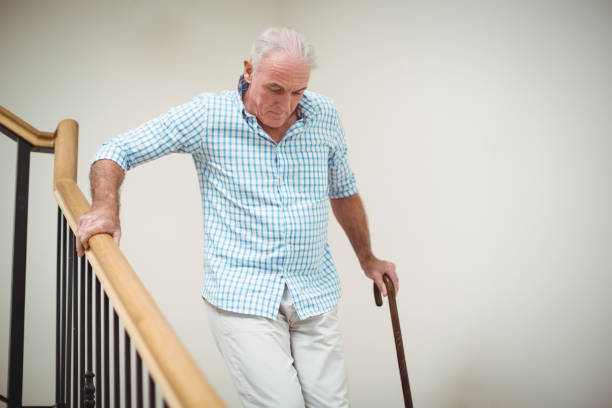 istock Senior man climbing downstairs with walking stick 645224436