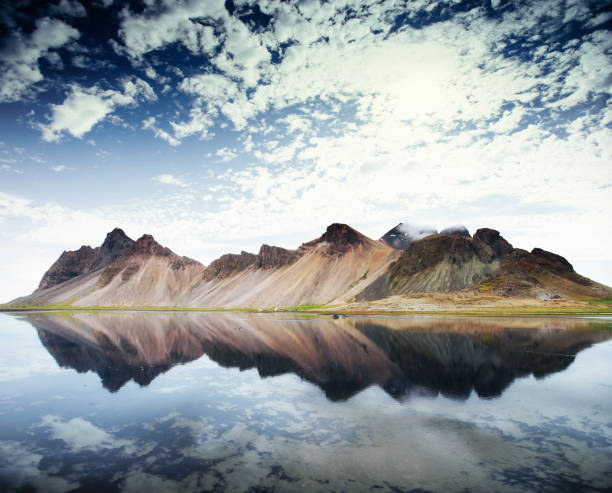 istock Amazing mountains reflected in the water at sunset. Stoksnes 645224868