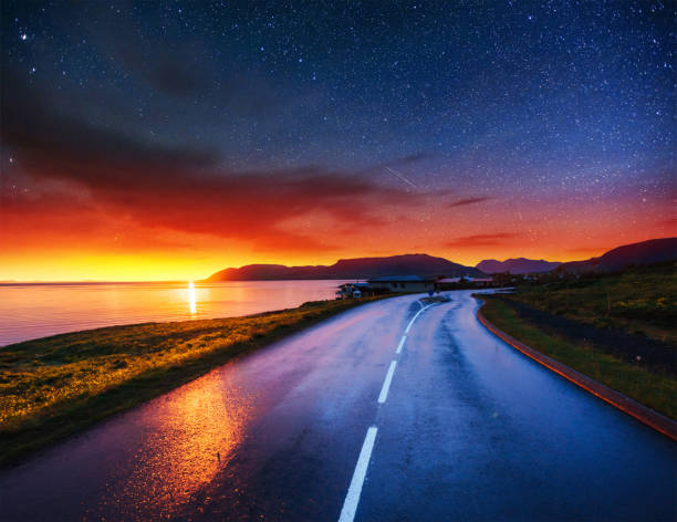 istock Starry Sky over the mountains. The asphalt road 645227598
