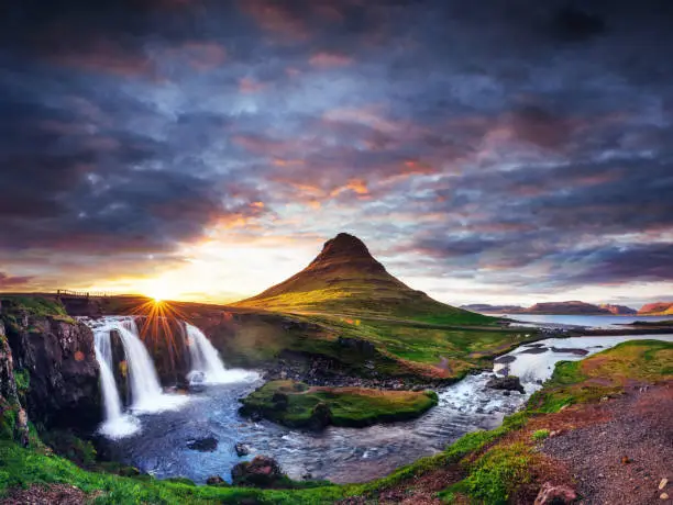 Photo of The picturesque sunset over landscapes and waterfalls. Kirkjufel