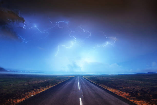 istock Lightning in cloudy dark sky and beautiful Asphalt road. Annual 645230586