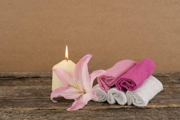 istock Composition with candle, pink lily and spa towels 645230880