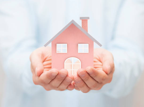 istock Small toy house in hands 645239506