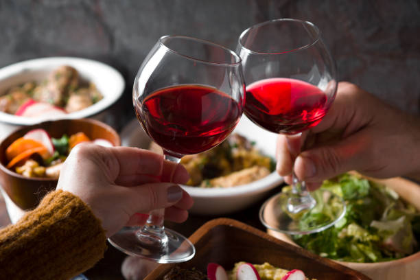 istock Glasses with a drink in his hand and a festive table closeup 645240804