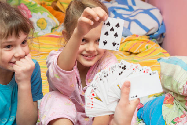 Children happily pull the card from the card fan